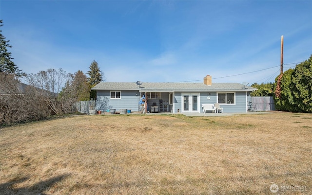 rear view of property featuring french doors, a yard, a patio area, and fence