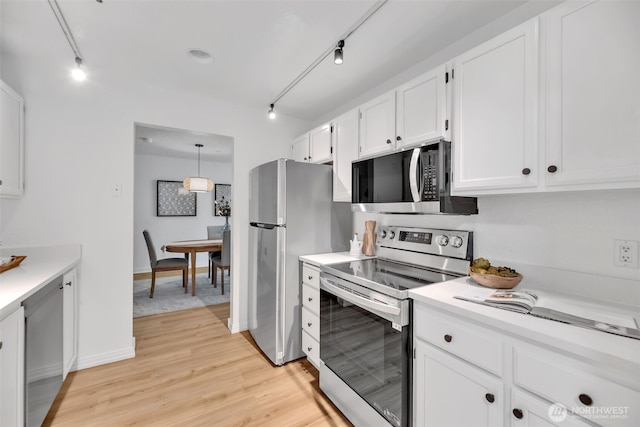 kitchen with white cabinetry, light countertops, light wood-type flooring, and appliances with stainless steel finishes