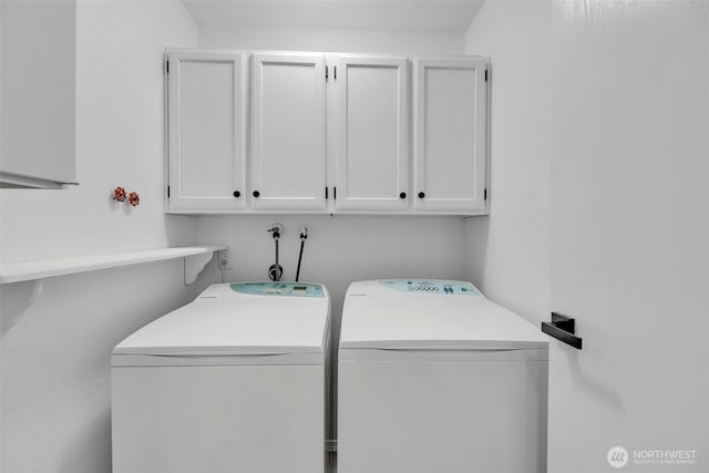 laundry room with cabinet space and washer and clothes dryer