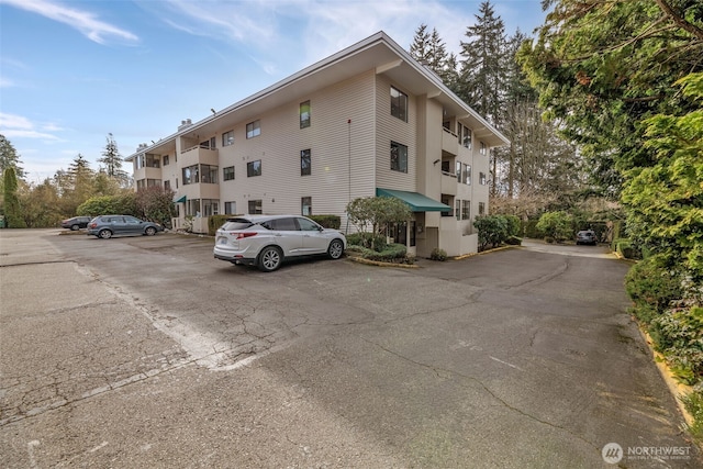 view of property featuring uncovered parking