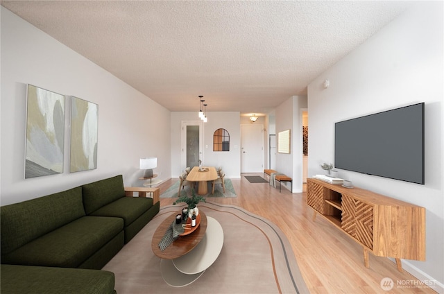 living room with a textured ceiling and wood finished floors