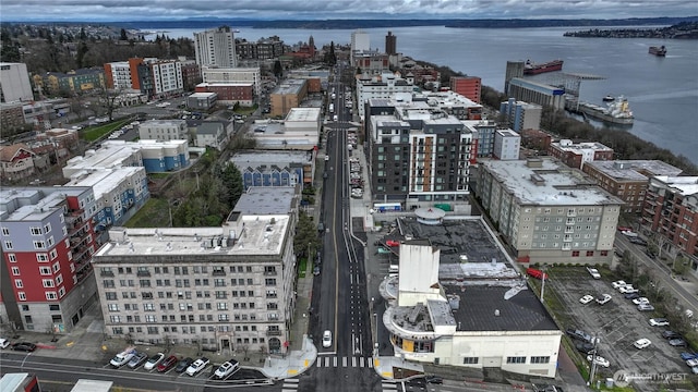 birds eye view of property featuring a city view and a water view