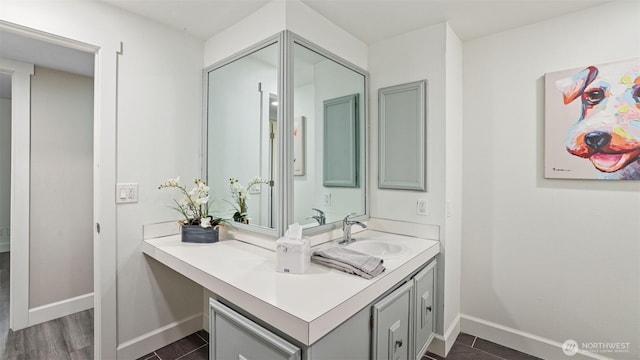 bathroom with vanity and baseboards