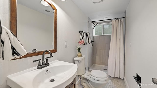 full bathroom with vanity, a shower stall, toilet, and visible vents