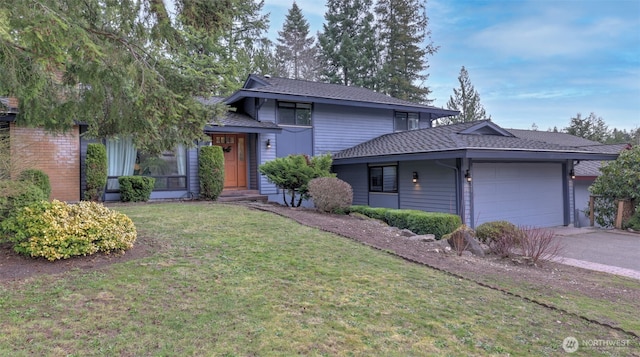 view of front of home featuring a front lawn, an attached garage, driveway, and roof with shingles