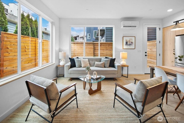 living area with recessed lighting, baseboards, and a wall unit AC