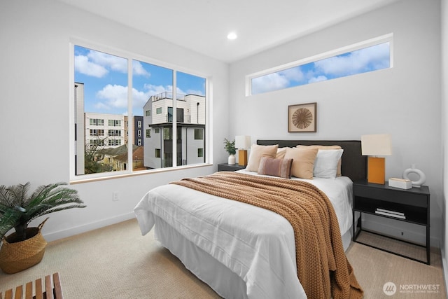 carpeted bedroom featuring recessed lighting and baseboards