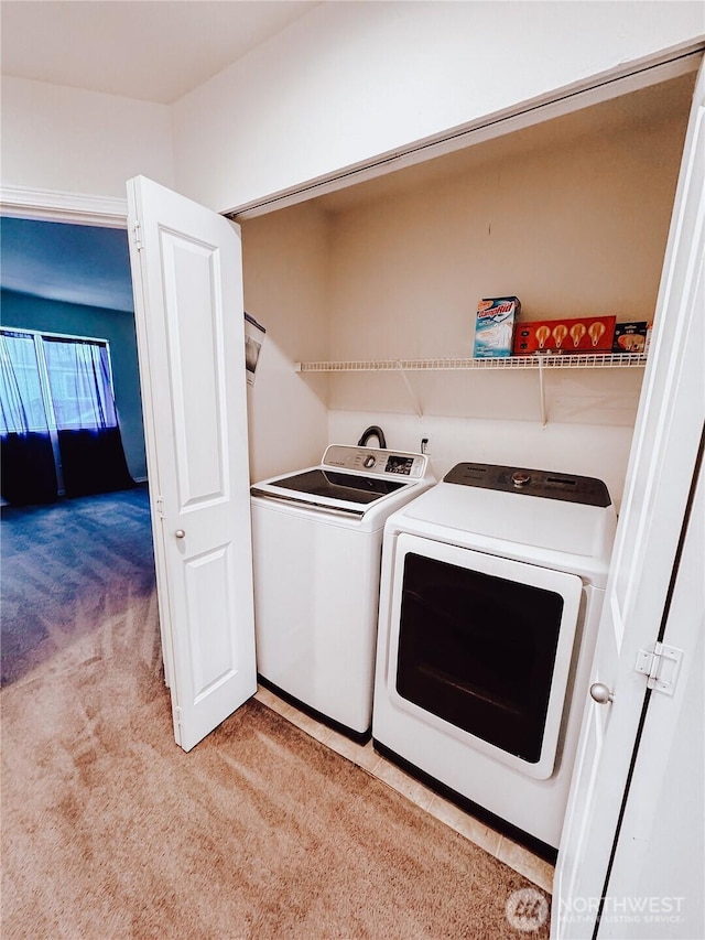 laundry room with laundry area, light colored carpet, and washing machine and dryer