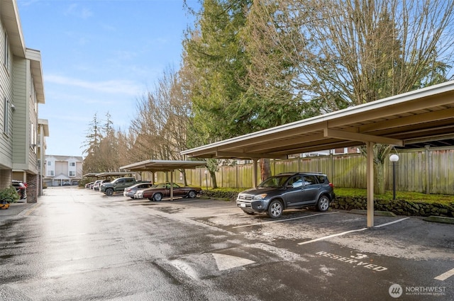 partially covered parking lot with fence