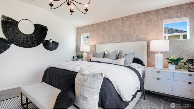 bedroom with baseboards, wallpapered walls, an inviting chandelier, vaulted ceiling, and dark carpet