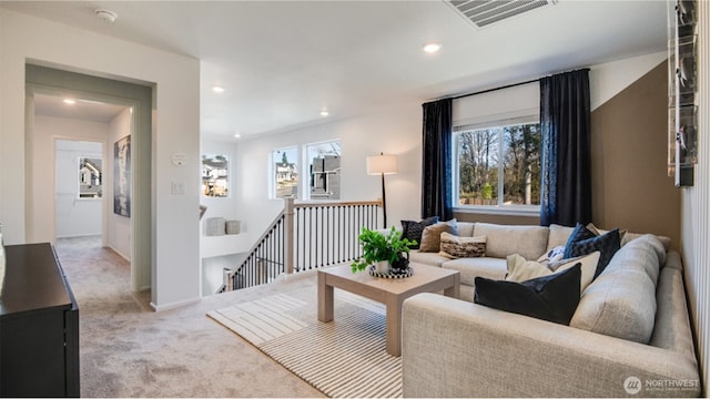 living area with recessed lighting, carpet flooring, a healthy amount of sunlight, and visible vents