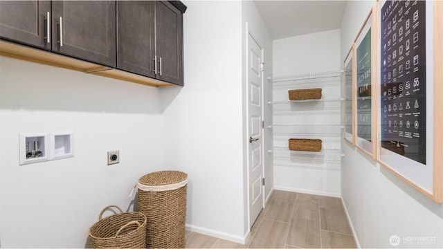 washroom featuring washer hookup, cabinet space, baseboards, and hookup for an electric dryer