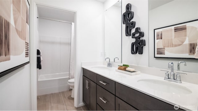 full bathroom featuring double vanity, toilet, shower / tub combo with curtain, and a sink