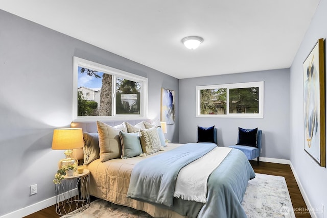 bedroom featuring wood finished floors and baseboards