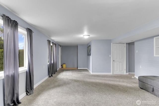 empty room with baseboards and carpet