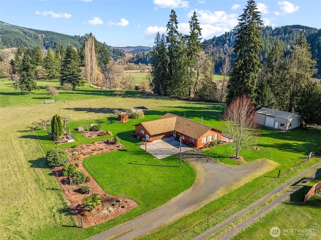 bird's eye view featuring a rural view, a mountain view, and a wooded view