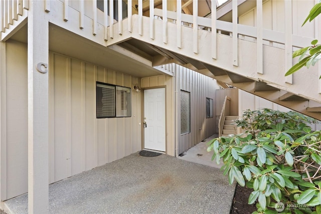 property entrance featuring board and batten siding