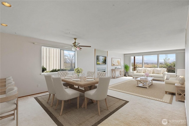 dining area with a ceiling fan and carpet floors