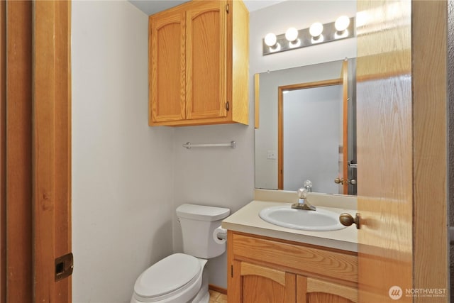 bathroom with toilet and vanity