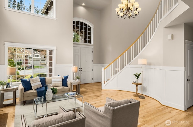 living room with plenty of natural light, a high ceiling, and stairs