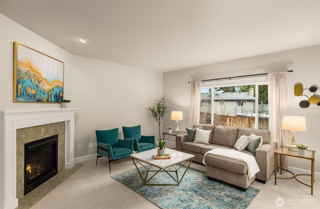 carpeted living room with baseboards and a fireplace