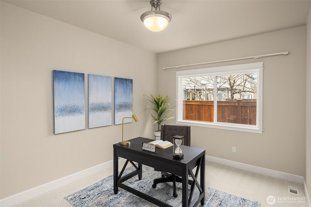 office area featuring carpet flooring, visible vents, and baseboards