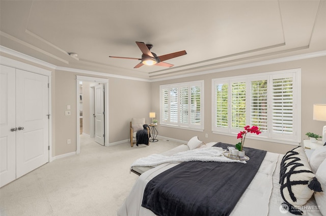 bedroom featuring baseboards, a raised ceiling, carpet floors, and ornamental molding