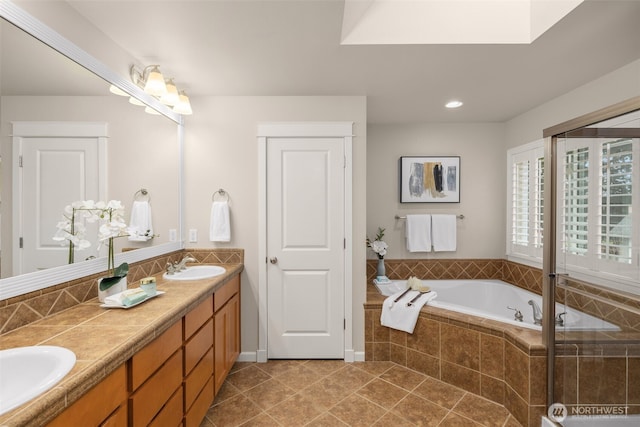 full bathroom with a sink, a garden tub, double vanity, and tile patterned flooring