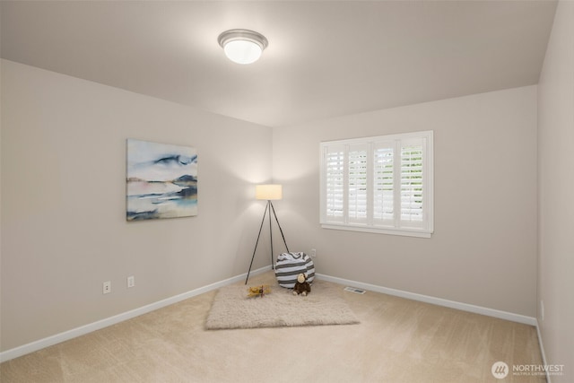 living area with carpet, visible vents, and baseboards