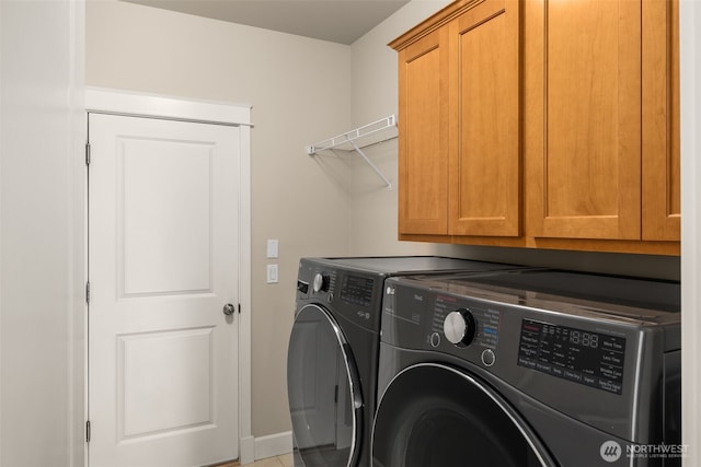 laundry area featuring washer and dryer and cabinet space