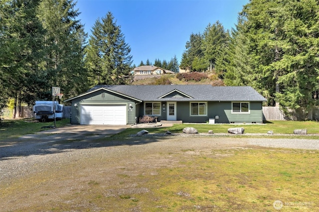 ranch-style home with a garage, concrete driveway, a front lawn, and fence