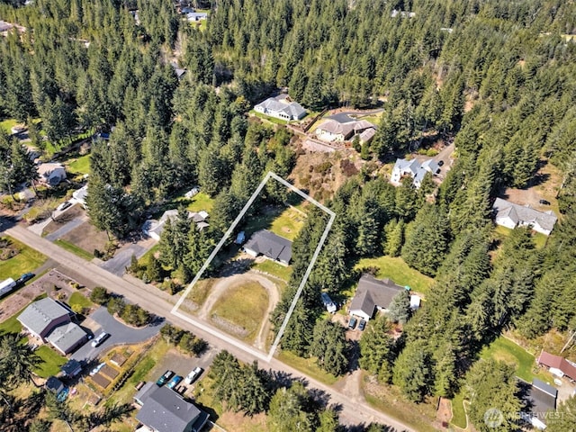 aerial view featuring a forest view and a residential view