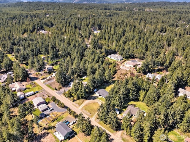 drone / aerial view featuring a wooded view