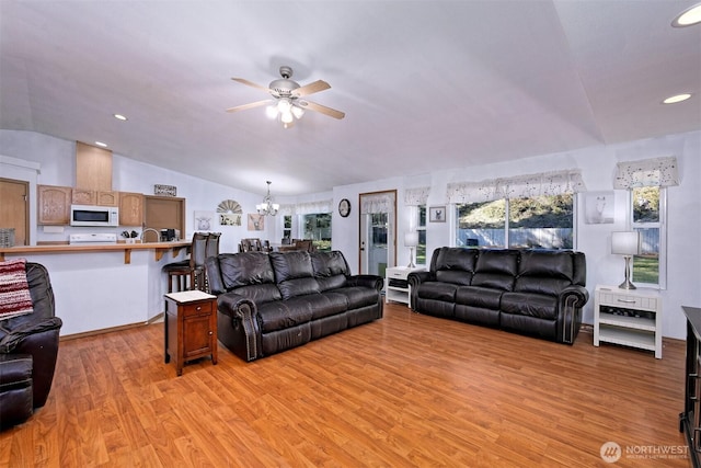 living room with vaulted ceiling, light wood-style flooring, recessed lighting, and ceiling fan with notable chandelier