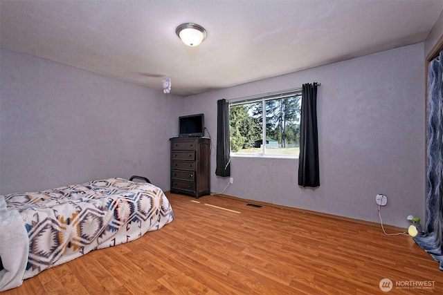 bedroom featuring light wood-style flooring and visible vents