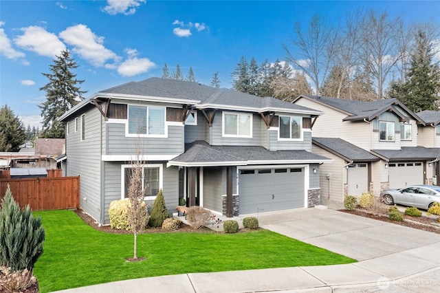 view of front facade featuring a front lawn, driveway, fence, roof with shingles, and a garage