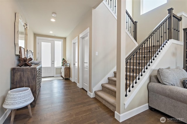 foyer with recessed lighting, baseboards, and dark wood-style flooring