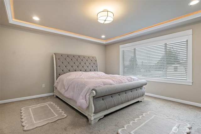 carpeted bedroom with recessed lighting, a raised ceiling, and baseboards