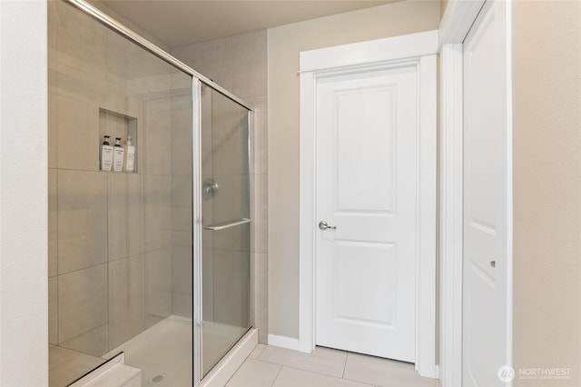 full bath with tile patterned floors and a stall shower