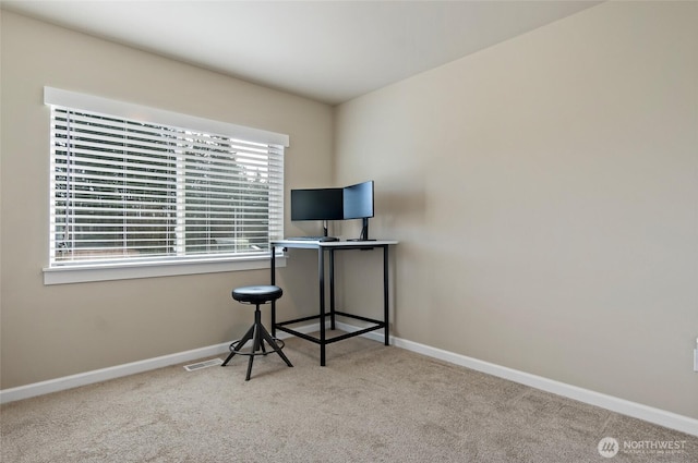 carpeted office space with visible vents and baseboards