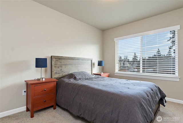 bedroom with light carpet, baseboards, and vaulted ceiling