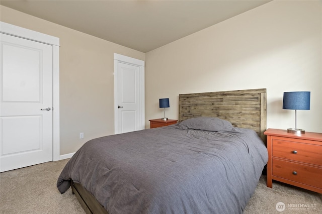 carpeted bedroom featuring baseboards