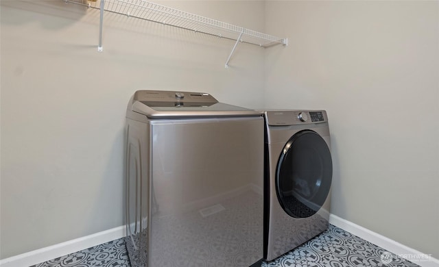 laundry area featuring baseboards, laundry area, and washer and clothes dryer