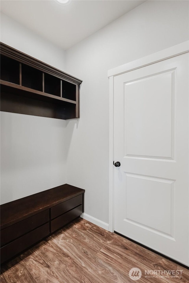 mudroom with wood finished floors and baseboards