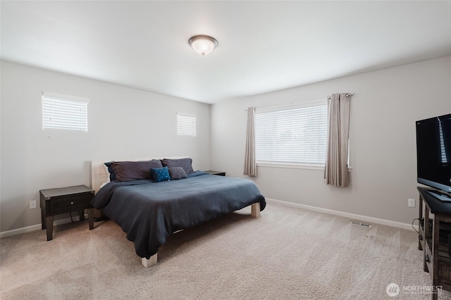 bedroom with visible vents, multiple windows, baseboards, and carpet