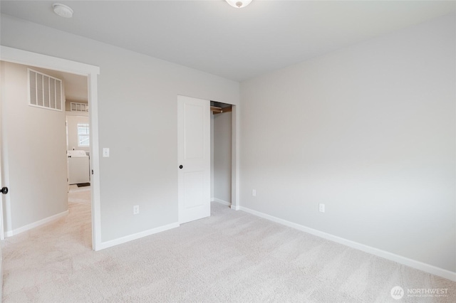 unfurnished bedroom featuring baseboards, visible vents, and light carpet