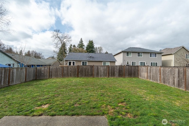 view of yard with a fenced backyard and a residential view