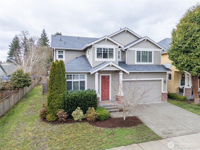 craftsman-style house featuring fence, a garage, and driveway