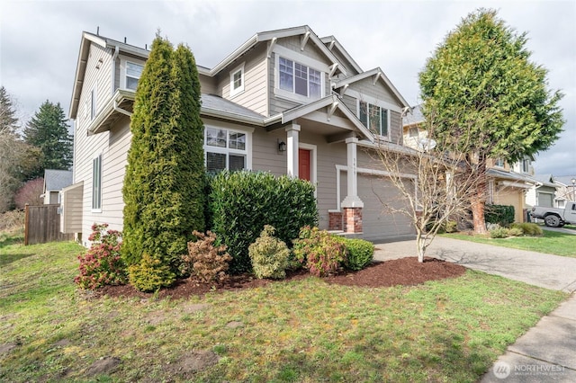 craftsman inspired home featuring a front yard, concrete driveway, and an attached garage