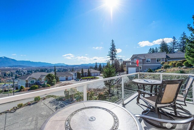 balcony featuring a residential view and a mountain view